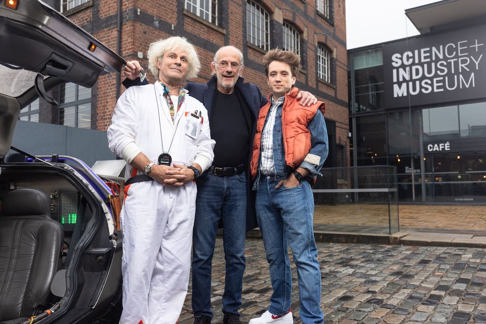 Christopher Lloyd hands Roger Bart the keys to the DeLorean back to the future musical